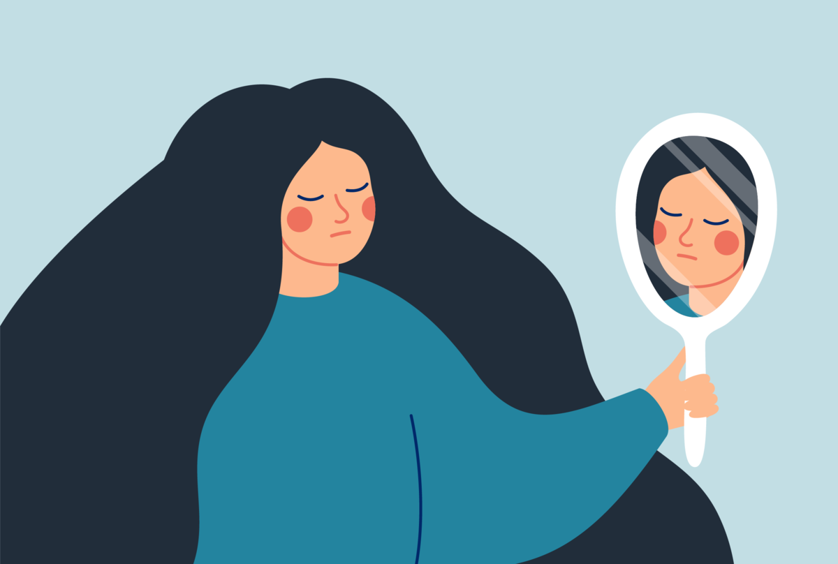 Na obrazku osoba, która patrzy w lustro i jest smutna.